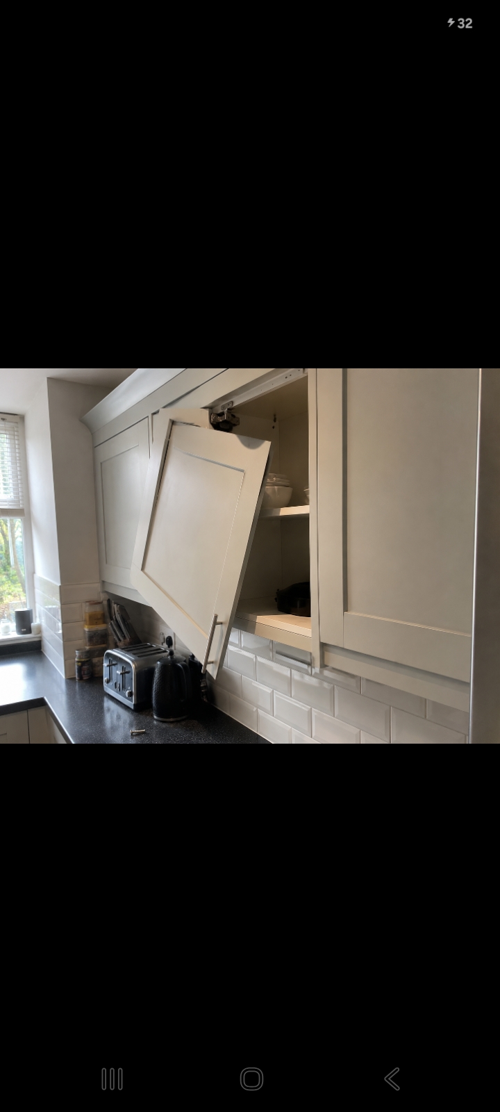 Loose kitchen cabinet door being repaired