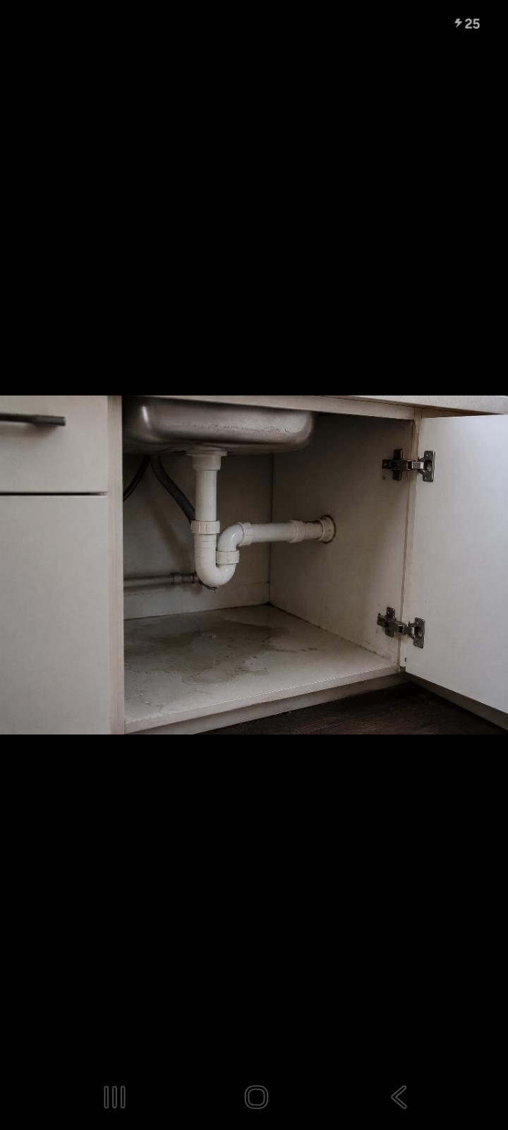 Leak visible under a kitchen sink cabinet
